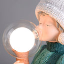 Resin table lamp featuring a design of a rabbit girl, with dual glass lampshades, and decorative elements resembling a baby bottle, cap, and eyelashes, adding a charming and whimsical touch.