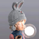 Resin table lamp featuring an elegant rabbit girl design with dual glass lampshades, detailed with costume hat and pattern elements.