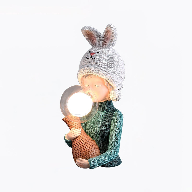 Resin table lamp featuring an elegant rabbit girl design with a dual glass lampshade, decorated with elements resembling wool and wood, and artistic details like a costume hat and fawn motifs.