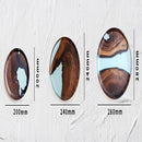 Handcrafted circular epoxy resin and wood tray with a glossy varnish finish.