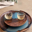 Handcrafted epoxy resin and wood tray displayed on a table, featuring a natural wood design and rectangular shape, suitable for serving dishes and drinks.