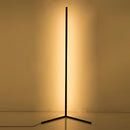 RGB corner floor lamp with LED lights, featuring a remote control, illuminating a room with amber and gold tints.