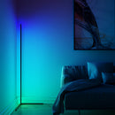 RGB corner floor lamp with LED light casting blue and purple hues in a cozy living room setting, featuring a couch and wooden elements.