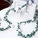 Battery-operated LED garland featuring rose flower string lights with green twigs and aqua accents, designed as a decorative fashion accessory.