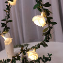 Battery-operated LED garland featuring rose flowers, twigs, and leaves, designed for interior decoration.