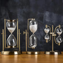 Elegant sand clock designed as a rotating globe hourglass, placed on a table.