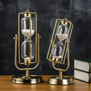 Elegant rotating globe hourglass timer with yellow sand, featuring metallic and brass components, displayed in a room setting.