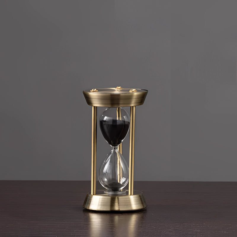 Elegant Rotating Globe Hourglass Timer on a table, featuring a cylindrical glass body with metal ends, filled with sand for a 10-minute timing, measuring 6.5 by 12 centimeters.