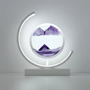 Dynamic 3D sand painting light featuring a violet and white LED table lamp, showcasing artistic and automotive design elements with circular and magenta graphics.