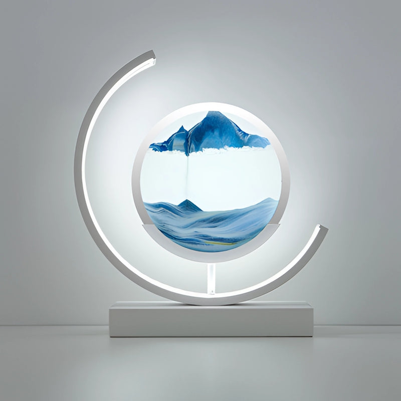 Blue and white Sand Art LED Table Lamp featuring a dynamic 3D sand painting light with abstract water-inspired art, displayed in a rectangular frame with circular electric blue accents.