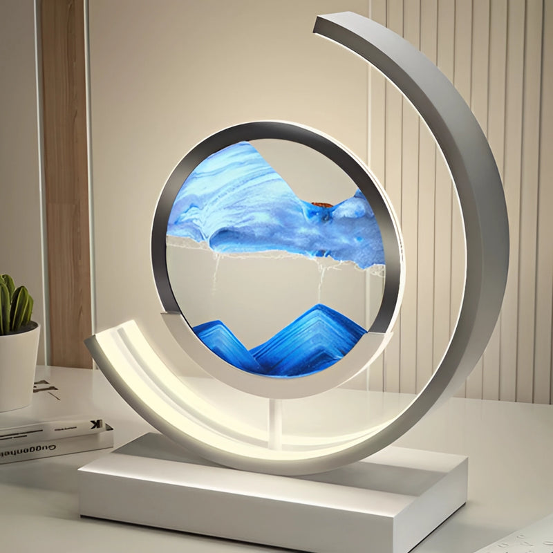 LED table lamp featuring a dynamic 3D sand art painting with a circular design, highlighted by shades of azure and electric blue, resembling air travel and space themes.