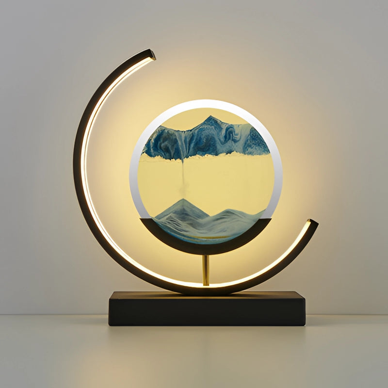 Blue and black Sand Art LED Table Lamp featuring a dynamic 3D sand painting light with artistic emblem and logo designs in a rectangular frame.