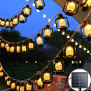 Solar string lights featuring outdoor LED lanterns in RGB and white colors, IP65 waterproof, displayed against a sky backdrop with amber and yellow tints, showcasing a circular art design at an event.