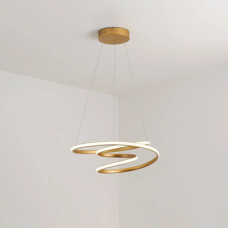 Elegant spiral pendant light made of aluminum with a modern design, hanging from a ceiling and providing warm illumination.
