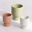 Ceramic flower pot resembling stacked coffee cups on a table, designed for gardening and bonsai.