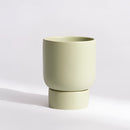 Large pale green stacked ceramic flower pot placed on a table, designed for garden and bonsai use.