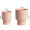 Beige ceramic stacked flower pot designed for garden and bonsai, featuring a cup-like shape and circular design elements, displayed on a table.