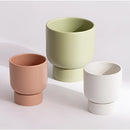 Ceramic vase designed as stacked flower pots, used for gardening or holding a bonsai, displayed on a table.