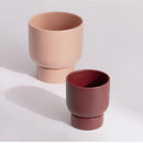 Ceramic flower pots stacked on a table, designed for gardening and bonsai, resembling cups and tableware.