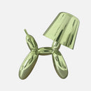 Dimmable table lamp featuring a crystal touch-sensitive base and a lime balloon dog design, displayed on a table.