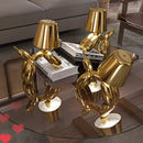 Crystal table lamp featuring a touch-sensitive, dimmable gold balloon dog design, emitting a soft amber light.