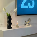 White and azure table lamp featuring a crystal touch-sensitive, dimmable design with a balloon dog motif, accompanied by a plant in a vase.