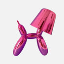 Pink crystal table lamp featuring a touch-sensitive, dimmable control and a balloon dog design, displayed on a table.