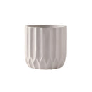 Large ivory textured ceramic polygon vase with a geometric design on a display surface.