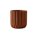 Large brown textured ceramic polygon vase with a geometric design, displayed on a wooden surface.