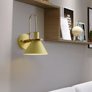 Elegant retro design wall light with a matt finish, featuring a lamp mounted on a wooden shelf, surrounded by art and picture frames, in an interior setting with a detailed ceiling and flooring.