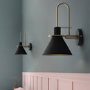 Elegant retro design wall light with a matt finish, featuring a grey lamp mounted on a wooden shelving unit against a wall.