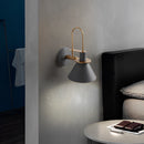 Elegant retro design wall light with matt grey finish, featuring a metal lamp mounted on a white wood wall in an interior setting.