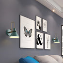 Elegant retro design wall light with a matte finish, featuring artistic butterfly motifs in a rectangular frame, suitable for interior decoration.