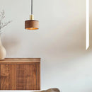 Rectangular walnut wood pendant lamp inspired by Japanese woodworking, hanging from a ceiling with a detailed wood stain finish.