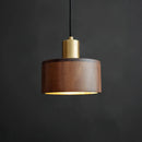 Walnut wood pendant lamp inspired by Japanese woodworking, featuring a cylindrical shape with metal accents, hanging from the ceiling.
