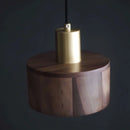 Walnut wood pendant lamp inspired by Japanese woodworking, featuring a cylindrical shape with metal accents suitable for ceiling installation.