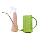 Pink and green watering tools set including a plastic watering can and a spray bottle.