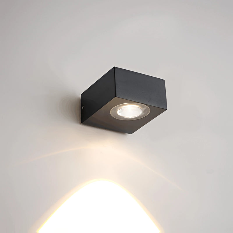 Black UFO-shaped waterproof wall light mounted on a wooden surface, featuring metallic elements and designed for both security and aesthetic appeal.