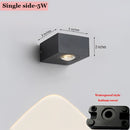 One-sided waterproof black UFO wall light made of aluminum and composite material, featuring a circular and rectangular design with components resembling audio and camera equipment.