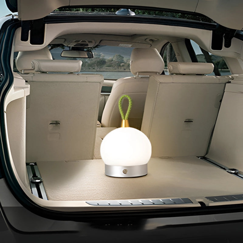 White car equipped with a waterproof LED lamp blimp featuring automotive lighting on the trunk and doors, highlighting its sleek design and lighting features.