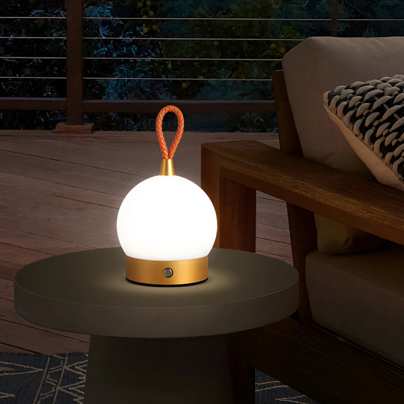 Cordless waterproof LED lamp blimp styled as a nightstand table light, displayed on a wooden floor with a focus on its sleek design and lighting effect.