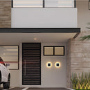 LED outdoor wall lamp mounted on a building, illuminating the surrounding area including a car and plant, showcasing its waterproof and durable design in an outdoor setting.