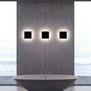 Outdoor wall-mounted waterproof LED light fixture made of aluminum, featuring a rectangular design against a backdrop that includes sky and architectural elements.