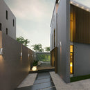 Modern Nordic style Empire waterproof LED outdoor wall light mounted on a building exterior, with surrounding elements including sky, clouds, plants, and urban road surface, illuminated by sunlight.