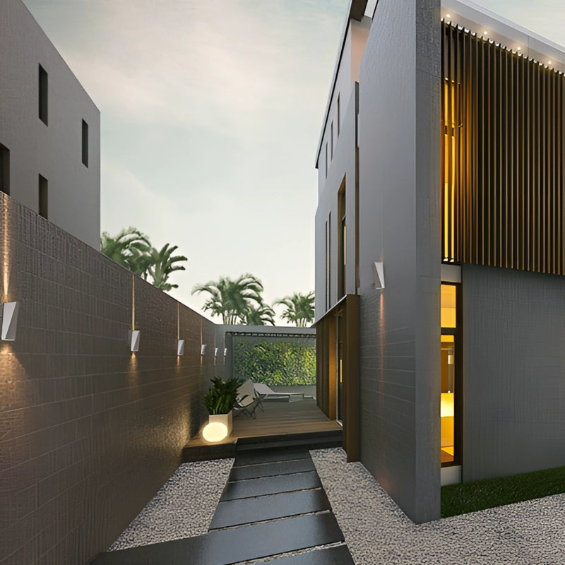 Modern Nordic style Empire waterproof LED outdoor wall light mounted on a building exterior, with surrounding elements including sky, clouds, plants, and urban road surface, illuminated by sunlight.