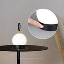 Cordless orb-shaped waterproof LED table lamp made of metal and wood, featuring an artistic design with a circular light fixture.