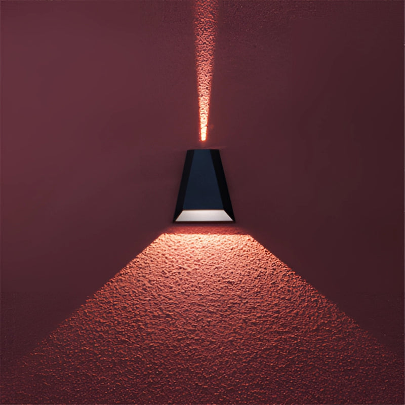 Outdoor pyramid-shaped LED wall sconce with a wooden design, featuring symmetrical lines and subtle shades, installed on a wall illuminating the area.
