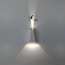 Outdoor pyramid LED wall sconce with a white body and warm white light, mounted on a wall emitting a soft glow.