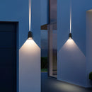 Outdoor pyramid LED wall sconce mounted on a wooden building, featuring a blue shade and rectangular design elements.