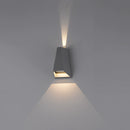 Outdoor pyramid LED wall sconce mounted on a wooden surface, featuring a circular light fixture with distinct shadows and ambient lighting.